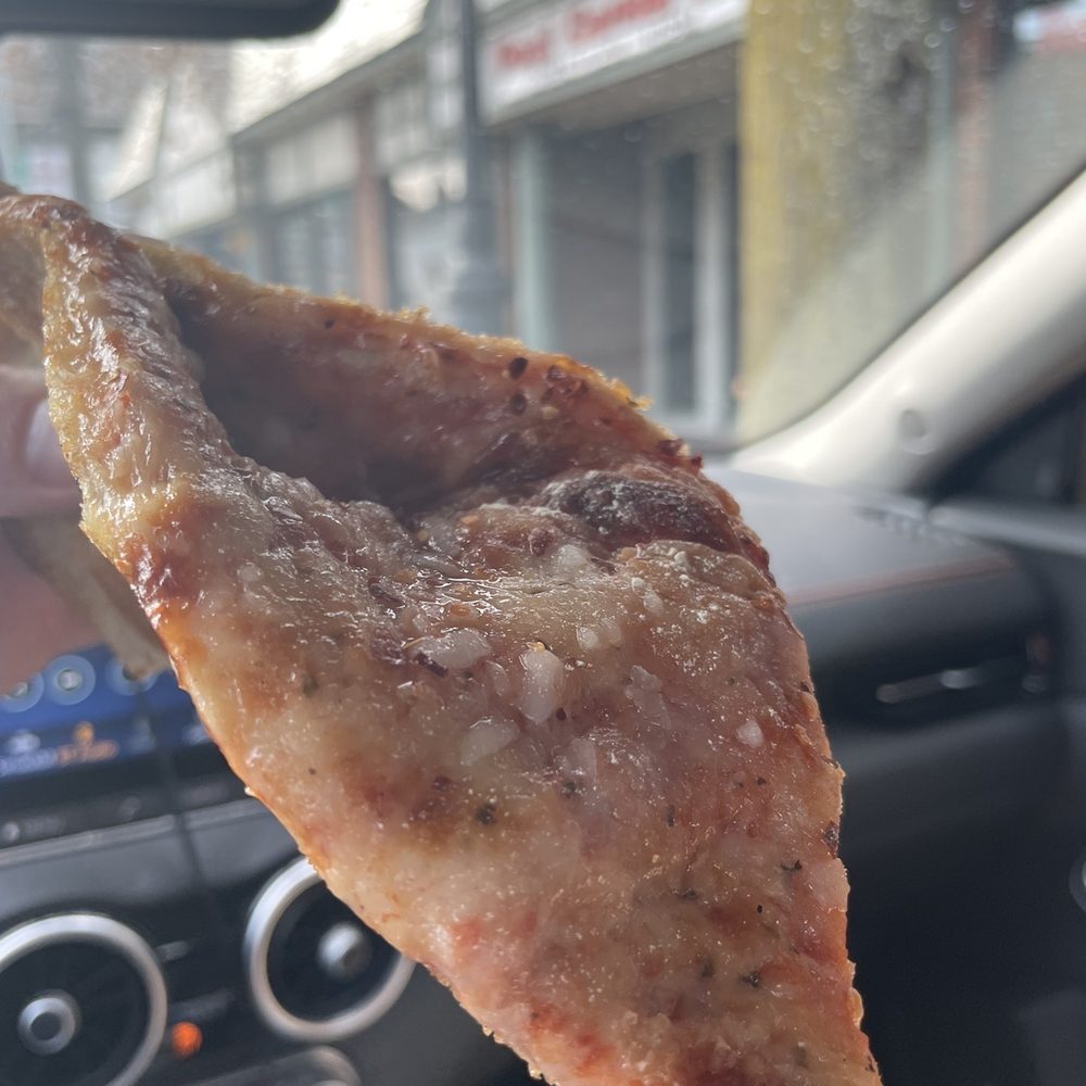 Post Corner Pizza - a person holding a piece of pizza - Pizza Near Me - Darien, Connecticut Post Corner Pizza - a person holding a piece of pizza - Pizza Near Me - Darien, Connecticut