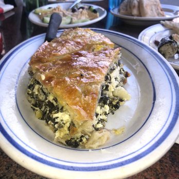 Lefteris Gyro - Tyropita Spinach Pie Spanakopita! (Longitudinal view of triangular pastry pie with layers of spinach and cheese) - Greek Near Me - Tarrytown, New York Lefteris Gyro - Tyropita Spinach Pie Spanakopita! (Longitudinal view of triangular pastry pie with layers of spinach and cheese) - Greek Near Me - Tarrytown, New York