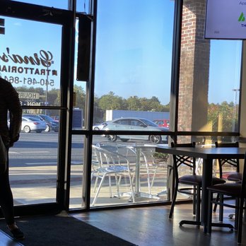 Gina's Trattoria - a woman standing in front of a window - Italian Near Me - Lexington, Virginia