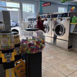 The lower level washing machines. Luz is cleaning the machines. The lower level washing machines. Luz is cleaning the machines.