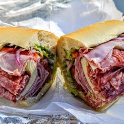 Mia Famiglia - Jersey Italian - ham, genoa salami, provolone, lettuce, tomatoes, red onion, vinegar, olive oil, and herbs on an  Italian roll.