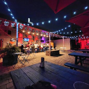 Spliff's Gastropub - a group of people sitting under umbrellas - Gastropubs Near Me - Jacksonville, Florida