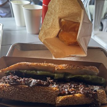 Cheesesteaks by Matū | Pasadena - Matū Philly Cheesesteak with nearly empty bag of House-made Wagyu Potato Chips - Cheesesteaks Near Me - Pasadena, California Cheesesteaks by Matū | Pasadena - Matū Philly Cheesesteak with nearly empty bag of House-made Wagyu Potato Chips - Cheesesteaks Near Me - Pasadena, California