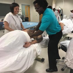 PowerUp Massage & Bodywork - Showing physical therapist assistant students some massage moves