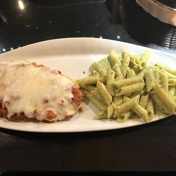 Cosmos Bar & Grill - Chicken Parmesan with penne pasta topped with freshly prepared pesto cream sauce - Bars Near Me - Hollister, California Cosmos Bar & Grill - Chicken Parmesan with penne pasta topped with freshly prepared pesto cream sauce - Bars Near Me - Hollister, California