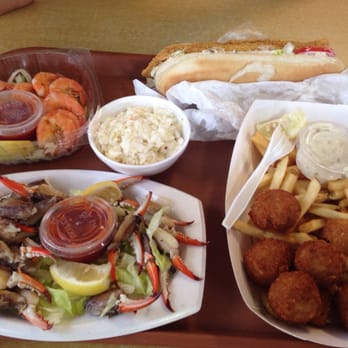 Shrimp N Stuff - From left to right...boiled shrimp, po boy catfish sandwich, crab balls w/ fries, fresh cold blue crab claws. - Seafood Near Me - Galveston, Texas Shrimp N Stuff - From left to right...boiled shrimp, po boy catfish sandwich, crab balls w/ fries, fresh cold blue crab claws. - Seafood Near Me - Galveston, Texas