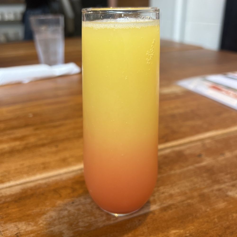 ACME Cafe - a glass of orange juice on a wooden table - New American Near Me - Salem, Oregon ACME Cafe - a glass of orange juice on a wooden table - New American Near Me - Salem, Oregon