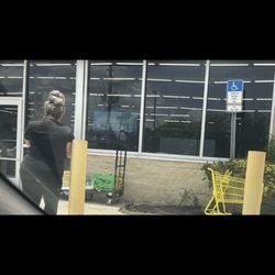 Dollar General - Manager smoking in front of the store.