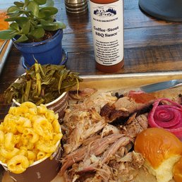 Pulled pork with collard greens and mac and cheese. BBQ sauce choices available on the side!