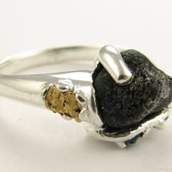 Wexford Jewelers - A custom design with the focus on the center stone which is meteorite.  Literally from out of this world!