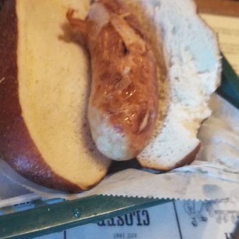 The Village Tavern - Brat on pretzel bun - American Near Me - Long Grove, Illinois The Village Tavern - Brat on pretzel bun - American Near Me - Long Grove, Illinois