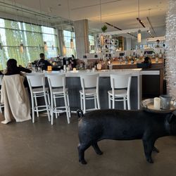 Mildred's Temple Kitchen - Entrance with serving pig near the bar