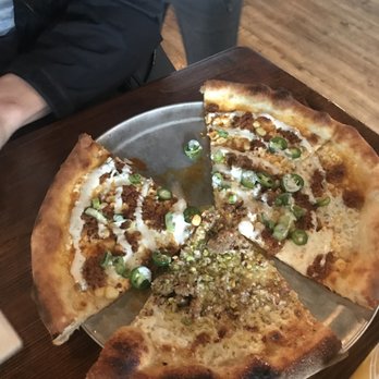 Nomad Eatery - The children of the corn pizza and a slice of pistachio pizza - New American Near Me - South Jordan, Utah