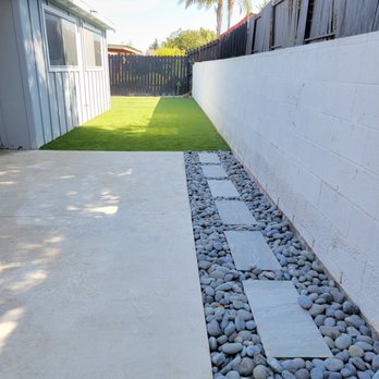 K5 Landscaping - To help with drainage, sloped concrete was removed along the retaining wall and pavers and river rock were added. - Landscaping Near Me - El Cajon, California K5 Landscaping - To help with drainage, sloped concrete was removed along the retaining wall and pavers and river rock were added. - Landscaping Near Me - El Cajon, California