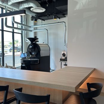 Couve Specialty Coffee - Some seating with coffee roaster on display - Coffee Roasteries Near Me - Las Vegas, Nevada Couve Specialty Coffee - Some seating with coffee roaster on display - Coffee Roasteries Near Me - Las Vegas, Nevada