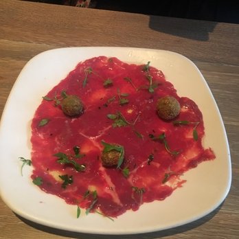 Panorama - Beef Carpaccio- dinner way to plate it but the red is actually meat and its super good. The ball looking things are also very tasty - Italian Near Me - Philadelphia, Pennsylvania Panorama - Beef Carpaccio- dinner way to plate it but the red is actually meat and its super good. The ball looking things are also very tasty - Italian Near Me - Philadelphia, Pennsylvania