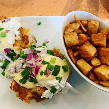 Another Broken Egg Cafe - Crab cake Benedict with a side of potatoes. I asked for no red pepper and to sub with red onion instead. - Cafes Near Me - Memphis, Tennessee