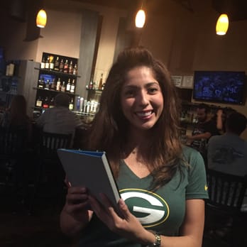 Elliott's - a smiling woman holding a book - Bars Near Me - Fresno, California Elliott's - a smiling woman holding a book - Bars Near Me - Fresno, California
