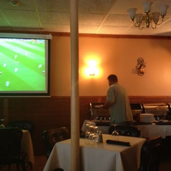 Serra Da Estrela - a man standing in front of a large screen - Portuguese Near Me - Cumberland, Rhode Island