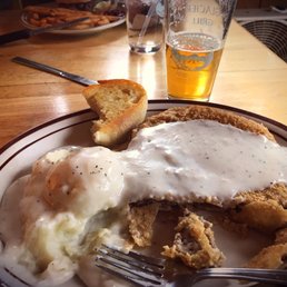 a plate of fried chicken with gravy and mashed potatoes a plate of fried chicken with gravy and mashed potatoes