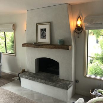 Treadlight Construction - a living room with a fireplace - General Contractors Near Me - San Diego, California