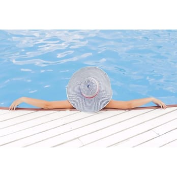 Everclear Pool & Backyards - a woman in a sun hat laying on the edge of a pool - Masonry/Concrete Near Me - Chattanooga, Tennessee