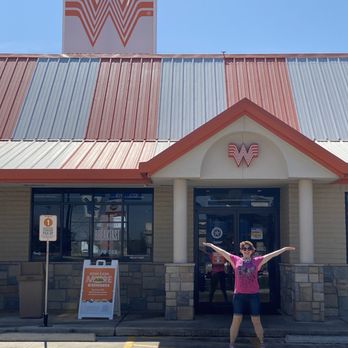Whataburger - a woman standing in front of a store - Fast Food Near Me - San Antonio, Texas