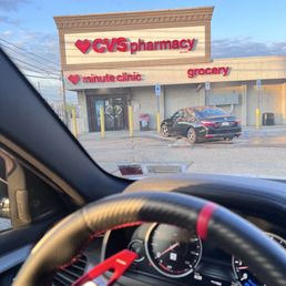 a view of a car in front of a pharmacy