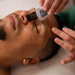 Karuna Integrated Wellness & Spa - Day-of skin analysis for a custom facial: gentle exfoliation, targeted serums, and soothing facial massage. LED Red Light included.