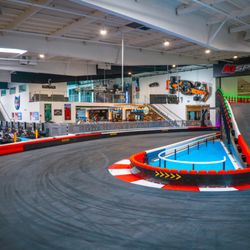 K1 Speed Culver City - A view of a hairpin turn, pit lane, and the Paddock Lounge in the background.