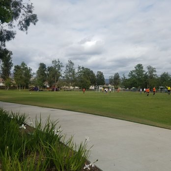 Valencia Park - View of the soccer field with the playground and schoolyard softball diamond in the distance - Playgrounds Near Me - Irvine, California Valencia Park - View of the soccer field with the playground and schoolyard softball diamond in the distance - Playgrounds Near Me - Irvine, California