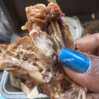 Wingstop - a person holding a piece of meat - Chicken Wings Near Me - Belton, Texas