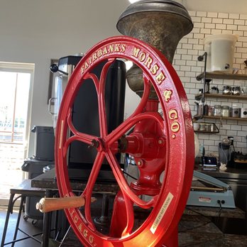 Global Coffee - a red coffee grinder in a coffee shop - Coffee & Tea Near Me - El Paso, Texas