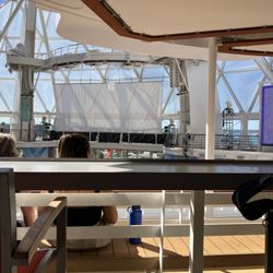 Travel Lady Vacations - Utopia of the Seas boardwalk neighborhood where water shows are done. Amazing to see & experience.