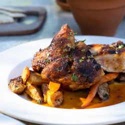 PlumpJack Cafe and Bar - Roasted chicken served with herb roasted potatoes, glazed baby carrots, lemon caper sauce.