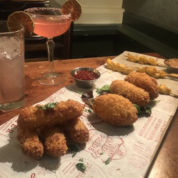 Bank - L to R: Halloumi cheese sticks with marinara, mac & cheese bites with red pepper jelly sauce, chicken satay with peanut sauce - Pubs Near Me - London, XGL Bank - L to R: Halloumi cheese sticks with marinara, mac & cheese bites with red pepper jelly sauce, chicken satay with peanut sauce - Pubs Near Me - London, XGL