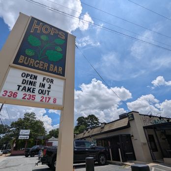 Hops Burger Bar - Outside. Storefront and street sign. - Burgers Near Me - Greensboro, North Carolina