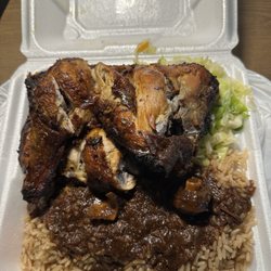 Large jerk chicken with oxtail gravy over rice and peas