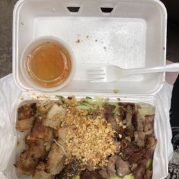 a styrofoam takeout box with a variety of food items