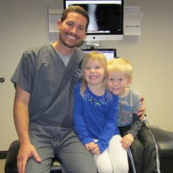 Dr. Elledge posing with happy patients.