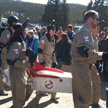 Frozen Dead Guy Days - Ghostbusters Coffin Race team in Hearse Parade - Local Flavor Near Me