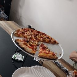 Most of a meatza plus cheeses and peppers