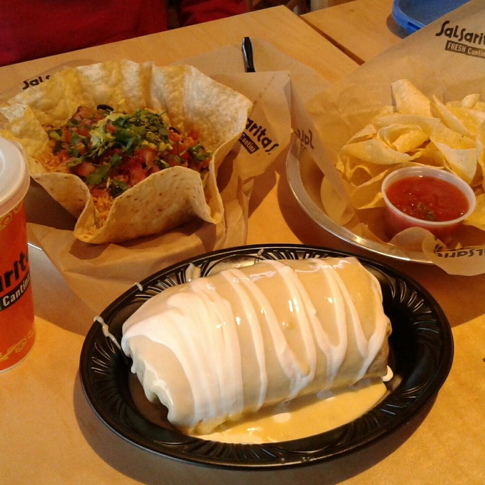 a burrito, chips and a drink a burrito, chips and a drink