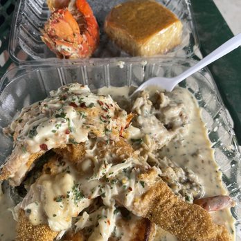 The Greasy Spoon - Dirty rice, Collard Greens, topped w Cajun fried catfish & Lobster Tail. Sautéed Shrimp & Crabmeat, SMOTHERED in Cajun seafood sauce. - Soul Food Near Me - Houston, Texas The Greasy Spoon - Dirty rice, Collard Greens, topped w Cajun fried catfish & Lobster Tail. Sautéed Shrimp & Crabmeat, SMOTHERED in Cajun seafood sauce. - Soul Food Near Me - Houston, Texas