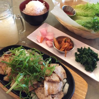 DOMA Korean Kitchen - The pork belly Korean barbecue plate, paired with the three sides of pickled veggies, kimchi, kale salad. The drink is a grapefruit slush. - Korean Near Me - Charlottesville, Virginia