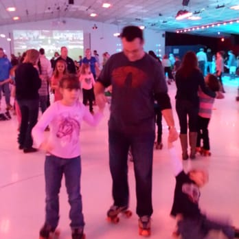 Roller Kingdom - My husband skating with two of our kids. - Skating Rinks Near Me - Tyngsboro, Massachusetts