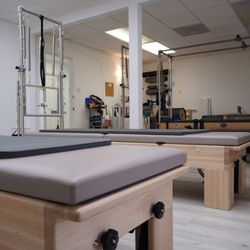 Pilates class studio with pilates reformer with tower mats
