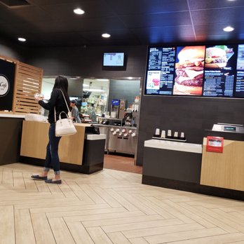 McDonald's - a woman standing in front of a counter - Fast Food Near Me - Kaufman, Texas