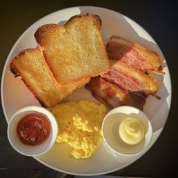 Scrambled eggs, bacon and brioche toast. Divine