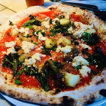Bruciato - Vegano Pizza with olives kale potatoes onions & vegan Mozzarella and Parm. You get side scissors to cut yo pizza - Pizza Near Me - Bainbridge Island, Washington